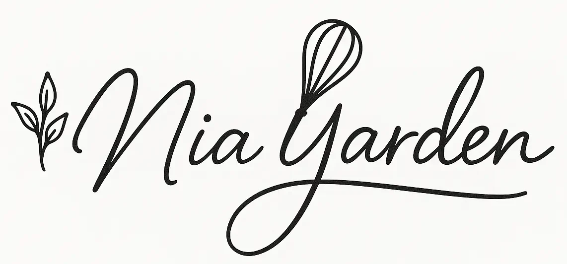 Elegant handwritten signature of the name "Nia Yarden" in black cursive with a whisk replacing the dot on the "i" and a small herb sprig on the left.