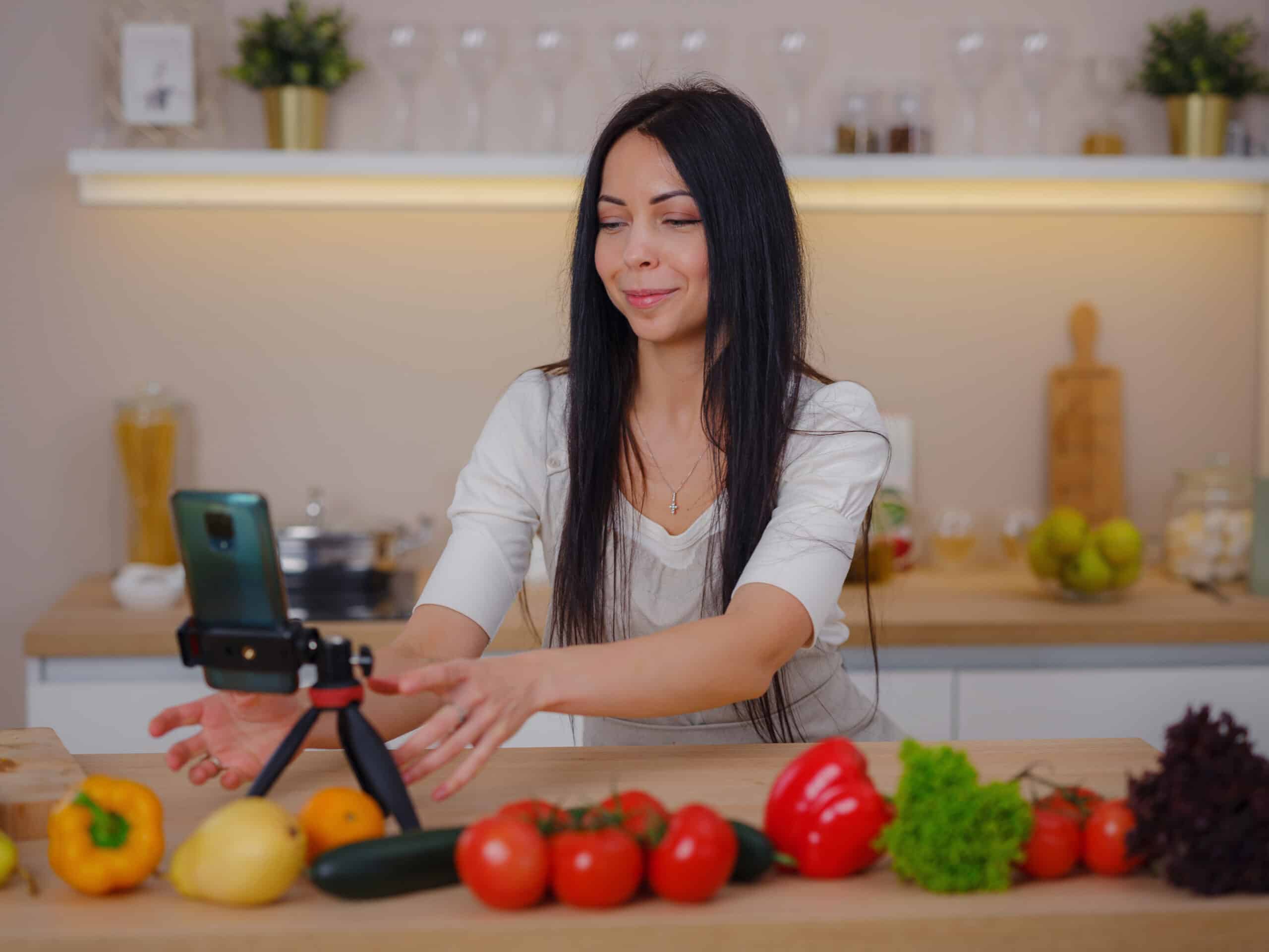 young woman is blogging for her kitchen Nia Yarden sitting at a kitchen counter