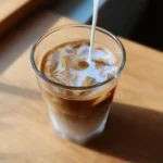 Dairy free coffee creamer being poured into hot coffee