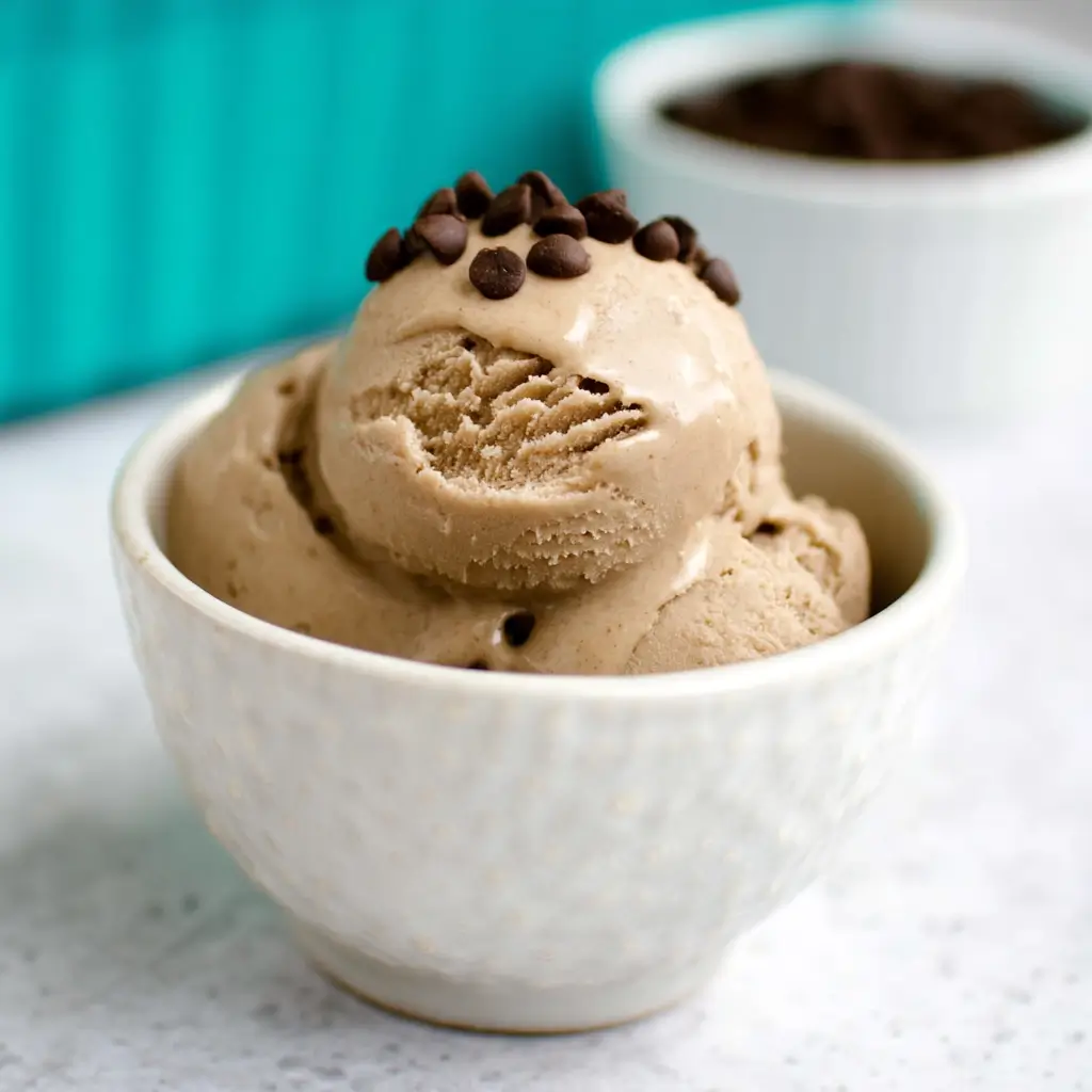 Espresso being poured over dairy free coffee ice cream for a vegan affogato